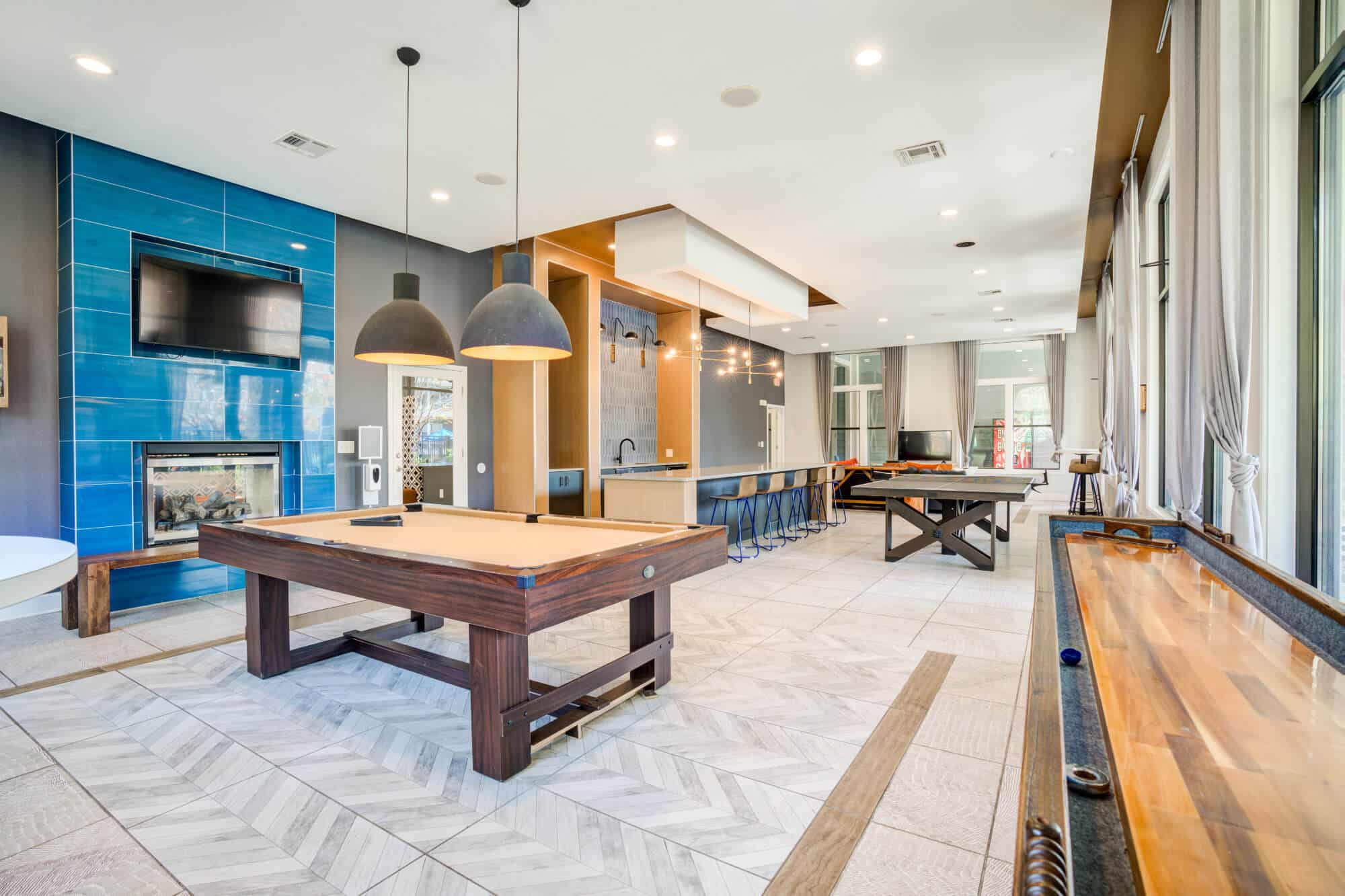 the mill at auburn off campus apartments near auburn university community amenities resident clubhouse game room with billiard shuffle board and ping pong tables